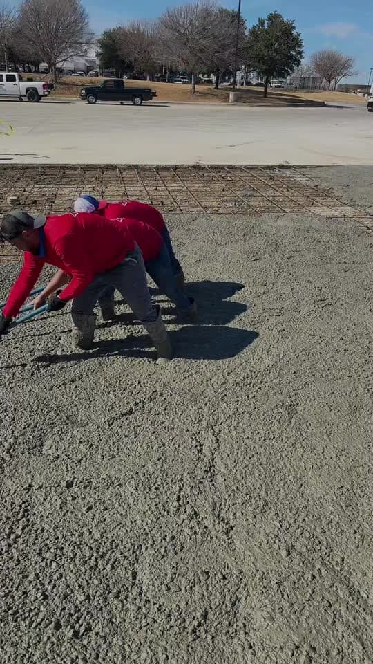 Texas Waterproofing crew placing concrete on a commercial lot